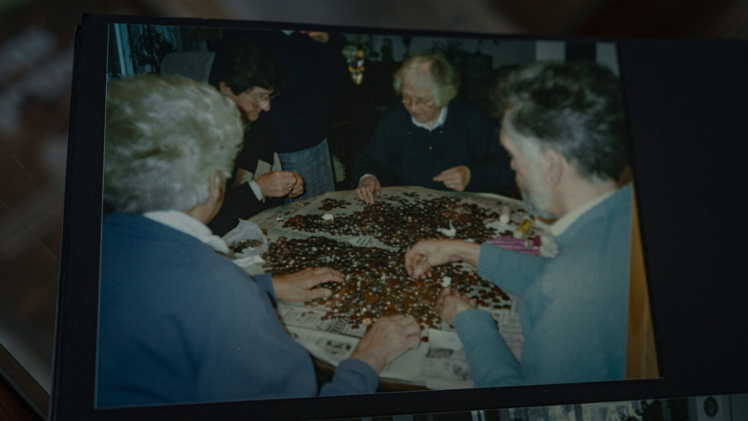 Heden 5 oudere mensen die samen legpuzzels maken aan een tafel, gezellig en interactief, vrijwillige zorg en ondersteuning, dorcas.nl.